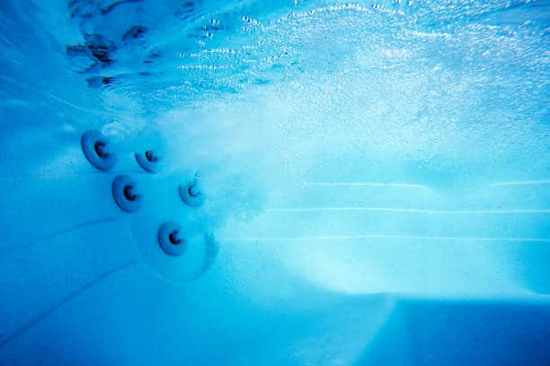 This is a close up underwater photo of a spa with jets for water massage. This is a close up underwater photo of a spa with jets for water massage.