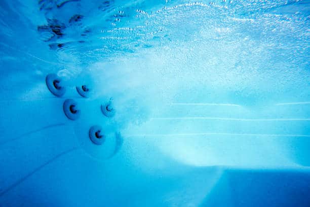 This is a close up underwater photo of a spa with jets for water massage.